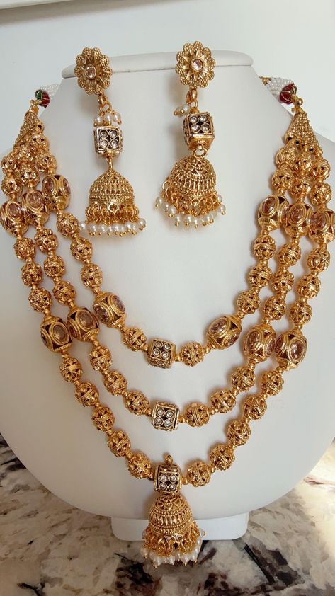 This exquisite piece of craftsmanship comes from our Traditional collection. Finish: 24 grams gold finish Length:20 Inches Indian Bridal  One Gram Jewelry Necklace Set. Necklace Fastening: Adjustable Dori Earring Fastening: Push Back Contains: 1 necklace, 1 pair of earrings Indian Necklace Gold, Gold Ball Necklace, Necklace Long Gold, Long Gold Necklace, Indian Necklace, Gold Long Necklace, Ball Necklace, Set Necklace, Necklace Beaded