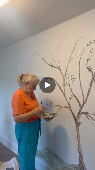 1.3M views · 31K comments | Mural for Isabella | It took me two days to paint a mural on the wall of Isabella's sunroom. I enjoy doing it so much for her as she is fixing up her parents old house for... | By Cooking with Brenda Gantt | Y'all. I'm at Isabella's house
and this is her sunroom. And she wants me to paint a mural
on the wall. I hate to do it because I ran a mess. Look. But
here it is. This is a solid white wall. And she I've got my
paints up here and my drop cloth and all that kind of
stuff. And I'm starting the picture. I meant to show y'all
before I started but then I forgot. So so far I've worked
it on the tree. You can see those limbs aren't done yet.
That's just my sketch that I did with my paint. And coming
along. I'll show you as we go, okay? Well, if I was painting
this Painting A Tree On A Wall, Paint A Mural, Cooking With Brenda Gantt, Drop Cloth, White Wall, I Forgot, White Walls, Old House, That Way