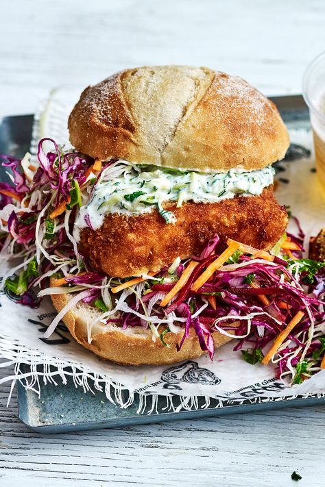 A fresh take on the classic fish burger. Polenta chips and zucchini tzatziki make it something a little bit special. Fish Burger Recipe, Polenta Chips, Fish Bbq, Instant Polenta, Kale Slaw, Fish Burger, Square Cake Pans, How To Cook Fish, Harvest Table