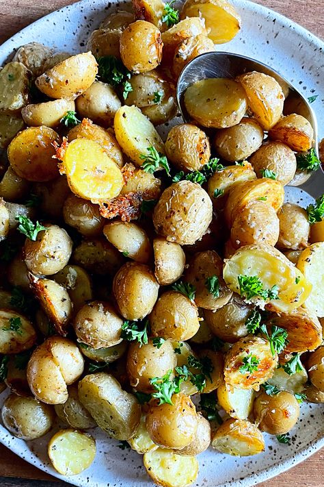 So quick and easy to make, they come together in minutes with ingredients you probably already have in your pantry – lots of aromatic basil, garlic, oregano and thyme + good quality olive oil. Just toss everything together and bake! | #potatoes #crispypotatoes #crispy #cheesy #garlicparmesan #potatorecipe #dinnerideas #dinnerrecipes #easysidedish Garlic Parmesan Roasted Potatoes, Oven Roasted Chicken Thighs, Parmesan Roasted Potatoes, Crispy Garlic, Roasted Chicken Thighs, Wholesome Recipes, Oven Roasted Chicken, Honey Garlic Chicken, Breakfast Cake