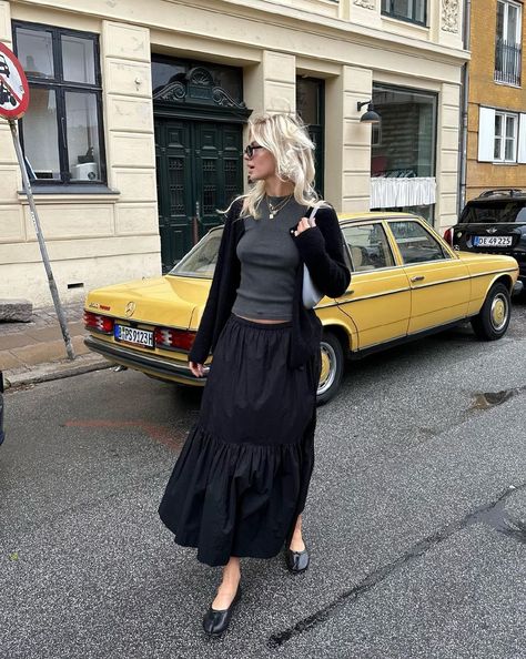 Button Down Maxi Skirt Outfit, Big Skirt Outfit Aesthetic, Tiered Skirt Outfit Winter, Tiered Black Skirt Outfit, Maxi Tiered Skirt Outfit, Modest Paris Outfits, Maxi Skirt Cardigan Outfit, Black Tiered Maxi Skirt Outfit, Long Tiered Skirt Outfit