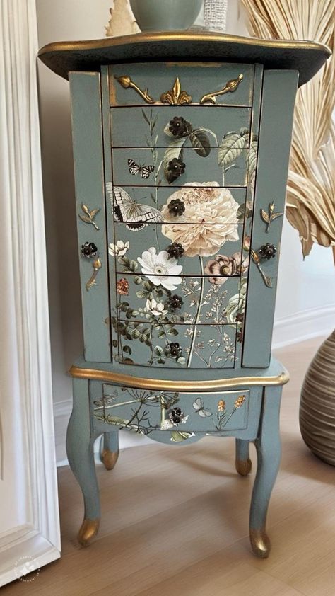 THIS SPECIFIC ITEM HAS SOLD, BUT I HAVE SEVERAL OTHERS IN PROGRESS. CONTACT ME IF INTERESTED, AND WE CAN CUSTOM DESIGN ONE JUST FOR YOU.  Absolutely stunning refinished jewelry armoire - I am literally obsessed with this piece After painting this in a lovely french blue called Duck Egg, not a detail was spared on decorating this piece. It has a fabulous, neutral floral design on the front, top and sides. All of the drawers, which are lined in green velvet, were decoupaged on both sides, which ma Jewelry Armoire Makeover, Diy Furniture Makeover Ideas, Painted Jewelry Armoire, Armoire Makeover, Dressers Makeover, Flower Embellishments, Furniture Rehab, Painted Jewelry, Painting Furniture Diy