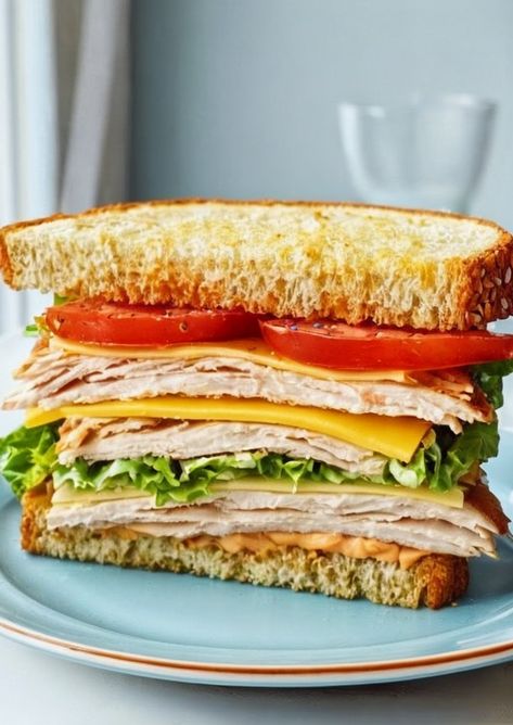 Savor the ultimate Turkey Club Sandwich: layers of juicy turkey, crispy bacon, fresh lettuce, and ripe tomatoes. Perfect for lunch! #SandwichRecipe #QuickLunch #EasyMeals Turkey Club Sandwich Recipes, Turkey Panini Sandwiches, Turkey Sandwich Thanksgiving, Club Sandwich Recipe, Turkey Panini, Turkey Club Sandwich, Turkey Melt, Turkey Wrap, Turkey Sandwiches Recipes