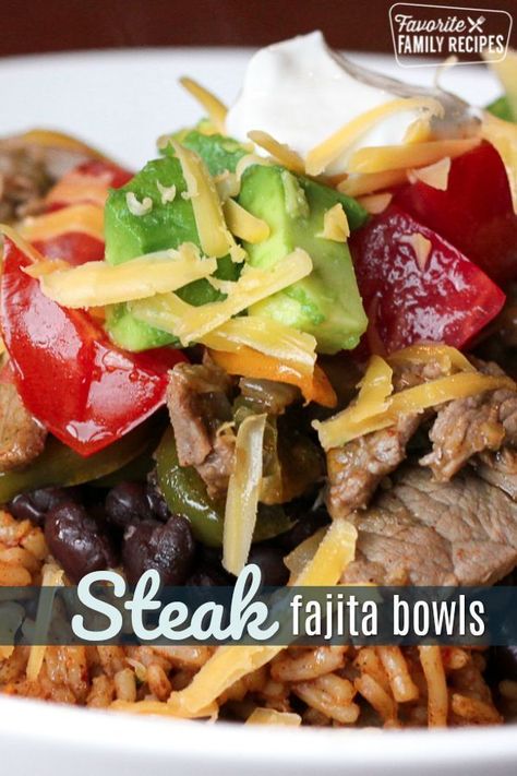 These Steak Fajita Bowls are like a fajita but in a tasty rice bowl. A perfect dinner made of tender steak and sautéed veggies over a bed of Spanish rice. #steakfajitabowls #steak #fajitas #mexican #rice #ricebowl #spanishrice #FavoriteFamilyRecipes #favf Fajita Bowl Recipe, Fajita Rice, Fajita Bowls, Rice And Beans, Steak Fajitas, Sauteed Veggies, Easy Family Meals, Beef Dishes, Quesadillas