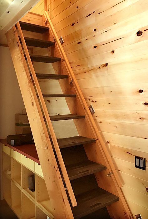 The nearly vertical incline of the staircase reminds one of a ship’s ladder. Ships Ladders Loft Stairs, Ship Ladder Stairs, Ship Ladder For Loft, Ships Ladder To Loft, Tiny Home Loft Ladder, Ladder To Loft, Tiny Stairs, Stairs To Loft, Ships Ladder