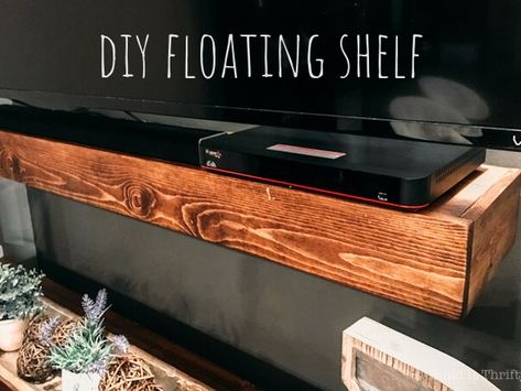 This is a floating shelf with a purpose! If you have a an outlet and cords you want to hide then this project is for you! Large Floating Shelf Under Tv, Floating Under Tv Shelf, Floating Shelves Hide Cords, Shelf To Hide Tv Cords, Under Tv Shelf Ideas, Diy Floating Tv Shelf, Shelves Under Tv Mounted Tv, Floating Shelf Under Tv Mounted Tv, Hide Outlets On Wall