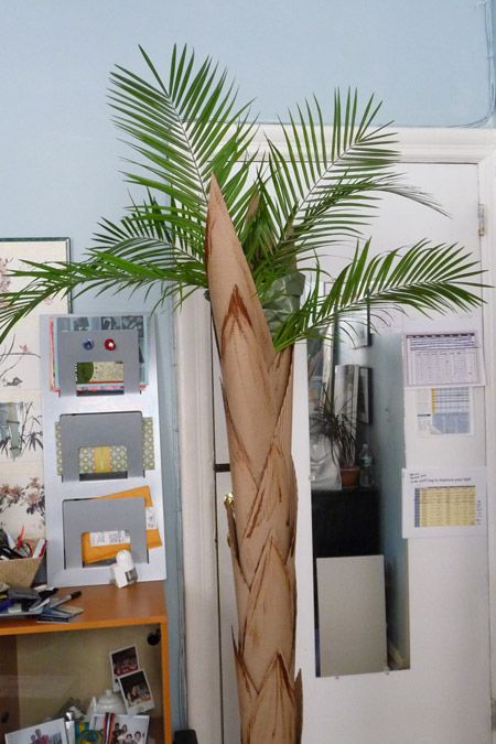 Cardboard palm tree made of cardboard tubes, corrugated cardboard, some tape and paint.  The leaves are the only things that are real. Cardboard Palm Tree, Palm Tree Diy, Cardboard Palm, Trek Ideas, Jungle Crafts, Egyptian Party, Jungle Decorations, Hawaii Christmas, Paper Garden