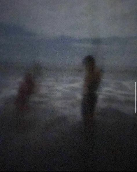 A blurry image of a young couple night swimming on a black sand beach in Ecuador. The grainy aesthetic makes the image look vintage. Late Beach Nights, Grunge Beach Pics, Swimming At Night Aesthetic, Night Blurry Aesthetic, Beaches At Night, Dark Beach Aesthetic, Swimming In The Dark, Night Beach Aesthetic, Beach Pollution