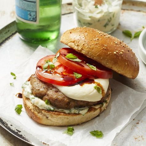 If you're a fan of caprese salads, you'll love this healthy turkey burger recipe. The patties are seasoned with Italian spices, then topped with juicy tomatoes drizzled with balsamic, fresh basil and fresh mozzarella. We've doubled down on the basil in this recipe by mixing it into the mayo and using whole leaves to top the burger, but if you prefer less basil flavor, you can swap out the basil leaves for spinach or arugula. Serve this summery burger with a simple side salad for a healthy ... Italian Turkey Burger, Italian Burger, Turkey Burger Recipe, Italian Turkey, Mediterranean Diet Recipes Dinners, Eating Well Recipes, Turkey Burger Recipes, Mediterranean Meals, Italian Spices