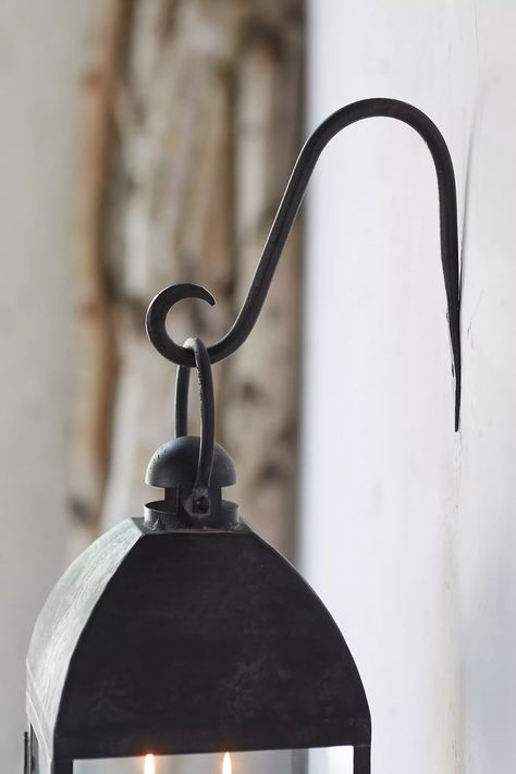 Iron Lantern Bracket | Anthropologie Lantern Pathway, Hanging Basket Garden, Lantern Hooks, Iron Lantern, Jewelry Hooks, Iron Lanterns, Pathway Lighting, Creative Living, Hand Poured Candle