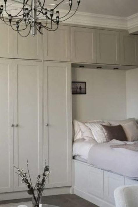 A studio flat with a wall-to-wall wardrobe extending over the bed Bed Along Wall, Wardrobe Design Around Bed, Ikea Pax Wardrobe Over Bed, Diy Bedroom Built Ins Around Bed, Wall Of Cabinets In Bedroom, Over Bed Built In Wardrobe, Fitted Wardrobe Ideas Around Bed, Built In Small Bedroom, Narrow Built In Wardrobe