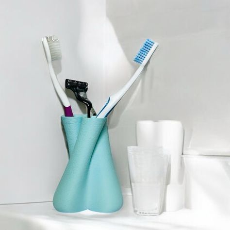 Keep your toothbrushes dry, clean, and organized with The Social Distancing Toothbrush Holder! Designed with a self-draining feature, this stand ensures that water drips away, keeping grime and bacteria at bay. The open bottom prevents stagnant water, while the angled slots provide perfect separation between toothbrush heads, offering a little "social distancing" for better hygiene. Sleek and functional, The Social Distancing Toothbrush Holder is the ideal addition to your bathroom, promoting... Organized Bathroom, Toothbrush Holders, Toothbrush Storage, Bathroom Themes, Soft Corals, Bathroom Essentials, Bathroom Organization, Social Distancing, Storage Solution