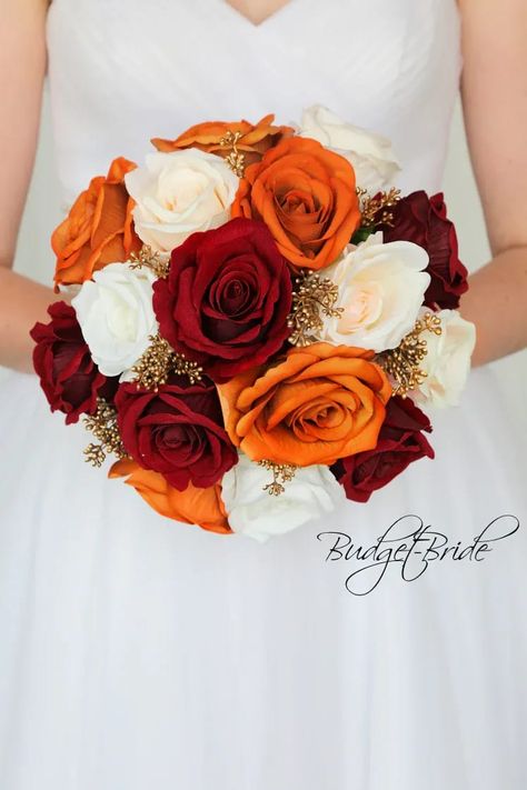 This is a round brides bouquet with a mixture of dark red, ivory and burnt orange roses accented with gold berries. All of our wedding bouquets are made with artificial wedding flowers. Wine Wedding Flowers, Red Rose Boutonniere, Bridal Colors, Wedding Boat, Gold Wedding Flowers, Shell Wedding, Orange Wedding Colors, Orange Bouquets, Orange Wedding Flowers