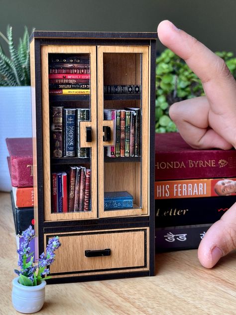 Step into a world of enchantment with our exquisite miniature handmade wooden classic doll furniture bookshelf with books. Crafted with precision and passion, each piece exudes timeless charm and attention to detail. Our miniature bookshelf is a perfect addition to any dollhouse, bringing warmth and character to every corner. Whether you're decorating a vintage-inspired parlor or a cozy library scene, this piece adds an authentic touch of elegance. Every tiny book on the shelf is meticulously cr Doll House Library, Bookshelf Miniature Scene, Diy Miniature Furniture, Bookshelf With Books, Children Bookshelf, Book Showcase, Library Scene, Miniature Bookcase, Dollhouse Library