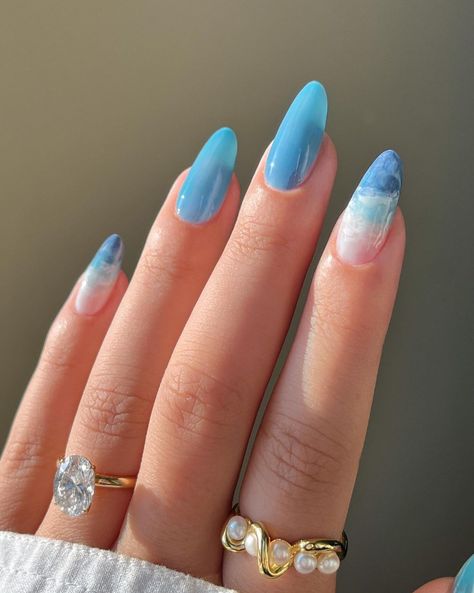 Bring the ocean to your nails with marine-inspired designs. Think of shades of blue, turquoise, and sandy beige to mimic the sea and the shore. Simple ocean nail art can include wave patterns, seashell accents, or even tiny starfish. You can also create a gradient effect with blue and white polish to resemble the water’s depths. These designs are not only beautiful but also remind you of the relaxing and serene nature of the beach. Ocean Blue Nails, Pool Nails, Ocean Nails, Nail Shades, Blue And White Nails, 2024 Nails, Summer Nail Art, Edgy Nails, Summery Nails