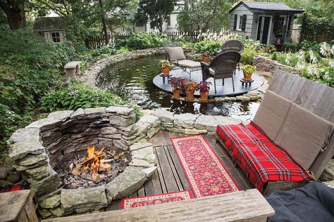 A luxurious, relaxing oasis with a stone fire pit and island-like seating atop a 3,000 - gallon pond. Pond Fire Pit Ideas, Koi Pond Fire Pit, Pond With Seating Area, Japanese Fire Pit, Relaxing Garden Spaces, Pond With Fire Pit, Pond Seating Area, Backyard Fire Pit Ideas Lounge Areas, Pond Fire Pit