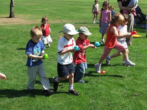 spoon, Plastic eggs, ping pong balls Cones or a jump rope to mark starting lines. Sand or rice to weight plastic egg if necessary. Make teams of 4-8 children. Have half the children to form a line on each line. Children walk and pass the egg to each other until the entire team has gone once. If the egg is dropped, start over at your starting line. If a team is one short, have one child go twice. Team who finishes first is the winner. Use a spoon that is appropriate for the age group. Easter Class Party, Work Christmas Party Games, Carnival Birthday Party Games, Recreational Therapy, Egg And Spoon Race, Toddler Party Games, Kids Easter Party, Easter Games For Kids, Games For Kids Classroom