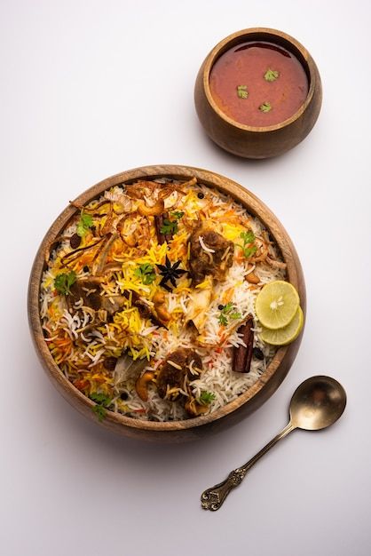 Mutton or lamb biriyani with basmati ric... | Premium Photo #Freepik #photo #mutton-biryani #biryani #basmati-rice #rice-dish Mutton Biryani Photography, Biriyani Photos, Biryani Plating, Rice Bowl Photography, Mutton Biriyani, Indian Food Menu, Lamb Biryani, Moody Background, Lamb Rogan Josh