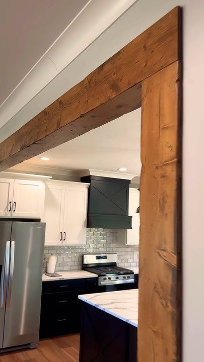 FAUX beam openings are KILLER #gotitcoach #woodworking #beams Faux Wood Beam Door Frame, Faux Wood Beam Ceiling Ideas, Beam Opening Kitchen, Faux Wood Beam Header, False Wood Beams, Faux Beam Pitched Ceiling, Faux Wooden Beam Doorway, Faux Beam Cover, Faux Beam In Kitchen