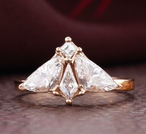 Elevate your engagement with this exquisitely crafted Moth Diamond Engagement Ring. Made from 18kt rose gold, it features trillion and kite lab-grown diamonds. This ring offers sustainable luxury, blending innovative design with eco-friendly materials. Perfect as a unique gift for her, symbolizing unmatched elegance and commitment. ●Stone Details ●Stone Type = Lab Grown Diamond ●Side Stone = Lab Grown Diamond ●Diamond Shape = Trillion &Kite Cut ●Diamond Color = DEF ●Diamond Clarity = VVS2-VS1 ●D Luxury Trillion Cut Engagement Jewelry, Luxury Trillion Cut Diamond Ring, Unique Diamond Rings Engagement, Elegant Trillion Cut Diamond Ring, Moth Wedding Ring, Moth Engagement Ring, Trillion Cut Ethical Diamond Ring In Rose Gold, Elegant Trillion Cut Rose Diamond Ring, Moth Diamond Ring