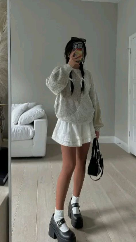 Cute summer fits for girls. White outfit ideas for women. White crew neck sweater and white flare mini skirt paired with black Mary Jane shoes outfit inspo. Casual chic outfit ideas. Aesthetic outfit ideas for girls. White Mini Skirt Winter Outfit, White Mini Skirt Outfit Aesthetic, White Skirt Boots Outfit, Outfits For Short Girls Aesthetic, Summer Outfit With Heels, Marry Janes Shoes Outfit, Maryjane Shoe Outfits Skirt, Coquette Mary Janes Outfit, White Mini Skirt Outfit Ideas