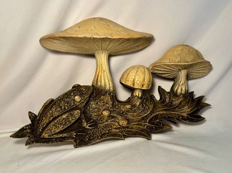 This vintage wall art from the 1970s is sure to add a touch of retro charm to your collection. Featuring a whimsical design of a hippy frog and mushroom, this 3D plaque is crafted from a combination of dense foam/ wood materials. Its 17x10 size makes it a perfect statement piece for any wall. The item has not been modified and is in its original state. Perfect for collectors of vintage and mid-century items, this wall plaque is a must-have for those who appreciate unique and playful decor. Frog And Mushroom, Foam Wood, Frog Mushroom, Playful Decor, Whimsical Design, Wall Plaque, Vintage Wall Art, Vintage Wall, Wall Plaques