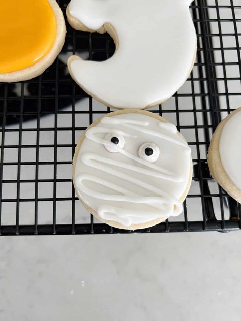 Ghost Sugar Cookies with Royal Icing for Halloween - traditionallycozy.com Ghost Sugar Cookies, White Food Coloring, Sugar Cookies With Royal Icing, Cookies With Royal Icing, Silicone Baking Sheet, Ghost Cookies, Sugar Cookie Royal Icing, Sugar Cookie Recipe, White Icing