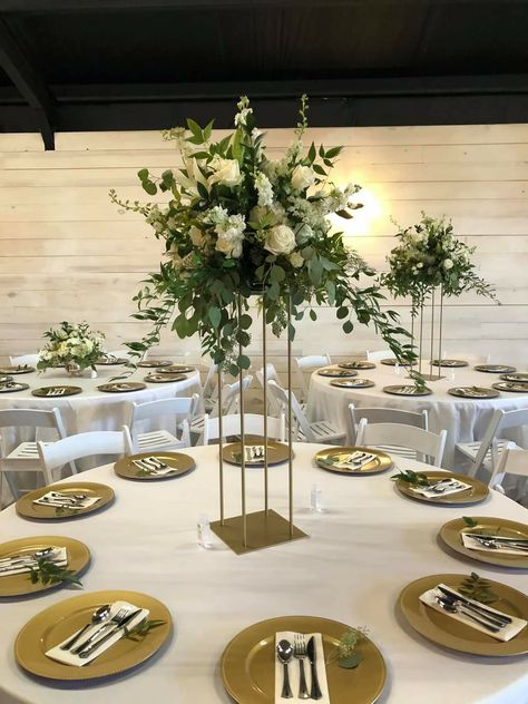 A mixed white centerpiece with mixed greenery atop a gold square stand White Centerpiece, Centerpieces Diy, Wedding Centerpieces Diy, Wedding Centerpieces, Table Decorations, Square, Gold, Furniture, White