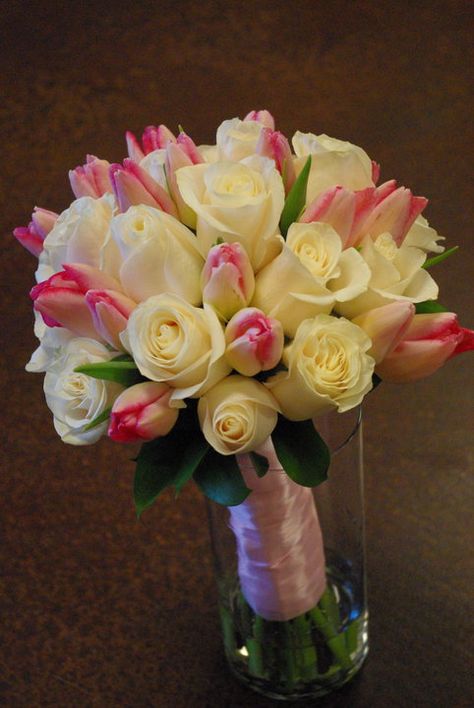 White roses with pink tulips made a beautiful bridal bouquet and she loved it!  #weddingflowers #bridalbouquet #whiterosebouquet Rose And Tulip Bridal Bouquet, Tulip Roses Bouquet, Roses With Tulips Bouquet, Bridal Bouquet Tulips And Roses, Tulip And Roses Bouquet, Tulips And Roses Bouquet, Roses And Tulips Bouquet, Rose And Tulip Bouquet, Tulip Bridal Bouquet