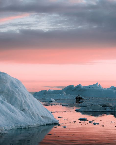 A pink sky is reflected in the arctic ocean. HIgh up in the north, the greenlandic fishing boat cruises through blue icebergs scattered around the cold landscape Drone Landscape, Shark In The Ocean, Coast Photography, Magical Sunset, Arctic Landscape, Hawaii Ocean, Under The Ocean, Underwater Animals, Arctic Ocean