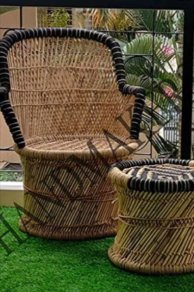 A bamboo chair embodies an organic and exotic appeal that instantly brings a touch of nature indoors. The chair's frame is constructed entirely or partially from bamboo, showcasing its distinctive grain patterns and earthy tones. Child Chair, Living Garden, Bamboo Canes, Bamboo Chair, Cane Furniture, Cane Chair, Low Table, Living Room Outdoor, Garden Area