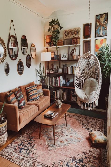 This cozy bohemian living room boasts vintage furniture, a comfy sofa, and a stunning hanging chair. The room is filled with greenery, colorful textiles, and an array of eclectic decor pieces, creating a warm and welcoming atmosphere that exudes boho charm. #bohemianlivingroom #vintagefurniture #hangingchair #bohodecor #indoorplants #cozy livingspace #eclecticstyle #colorfultextiles #bohohome Living Room Boho Vintage, Boho Artsy Living Room, Papasan Chair Living Room Decor Ideas, Bohemian House Decor Living Room, Living Room Decor Cozy Vintage, Boho Lounge Room Ideas, 70s Boho Living Room, Boho Lounge Room, Hippy Living Room