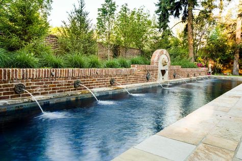 Antique bronze rosettes spit water from the rustic brick wall that borders the long pool. Pool Brick Wall, Courtyard Pools, French Pool, Long Pool, Backyard Pool Design, Dipping Pool, Swimming Pool Pond, Pool Inspiration, Pool Play