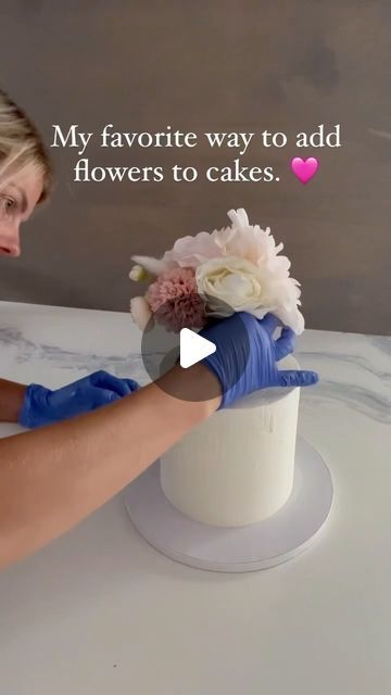 Kupcake Konnoisseur on Instagram: "A few months ago, I began incorporating flowers into my cakes using a new method, and I’ve absolutely fallen in love with it for several reasons.

✨ First, this approach allows the flowers to be preserved as a keepsake. Once the cake has been enjoyed, the entire arrangement of flowers can be effortlessly removed in one go, leaving you with a beautiful bouquet to cherish.

✨ Second, if you’ve ever spent time meticulously smoothing the sides of a cake, you know how disheartening it can be to pierce holes all over it just to add decorations. With this method, your cake stays perfectly smooth and pristine even after the flowers are removed, ensuring it looks stunning from start to finish.

✨ Lastly, this technique takes the guesswork out of flower placement. Cake With Flowers On Side, Celebration Of Life Cake Ideas, Real Flowers On Cake, Flowers On Cake, Cake With Icing, Arrangement Of Flowers, Cupcakes Wedding, Toppers Diy, Cake With Flowers