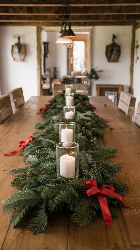 Use faux snow, silver chargers, and white dishes. Add shimmering candle holders or lanterns, snowflake table runners, and crystal-clear glassware to evoke a frosty winter vibe. A frosted centerpiece, like a small pine tree or snow-covered branches, completes the look. Garland Table Runner Christmas Centerpieces, Long Christmas Table Centerpieces, Rectangle Christmas Table Decor, Christmas Centerpiece Long Table, Large Christmas Table Centerpieces, Farm Table Christmas Decor, Large Christmas Centerpieces For Table, Long Christmas Table Decor, Christmas Decor Dining Room Table