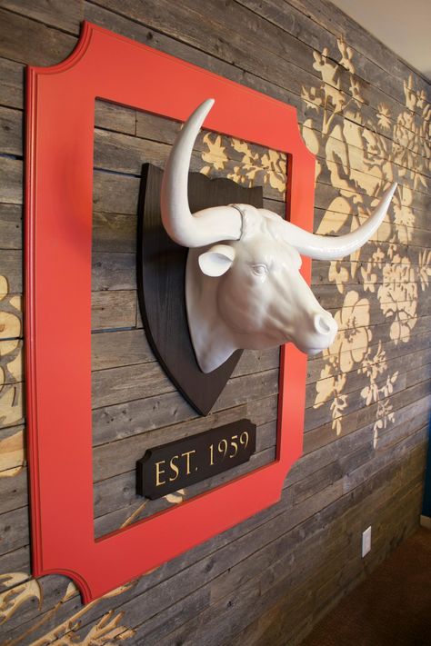 This small transitional guest room features a floral-patterned wood-slat wall that complements the room's neutral palette. A red-framed faux mounted bull head makes for a dynamic focal point while adding color and texture to the space. Transitional Guest Bedroom, Bull Pictures, Creative Technology, Wood Slat Wall, Bull Head, Wood Carving Art, Luxury Homes Dream Houses, Slat Wall, Animal Heads