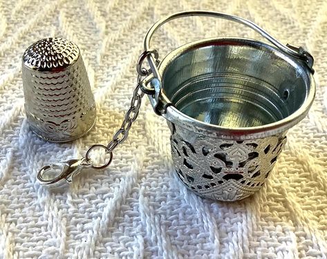 A beautiful thimble holder in the form of a miniature bucket, based on the designs of genuine Victorian thimble holders, it is perfect for your chatelaine and your crafting session. This tool is specially designed to hang on either a necklace or chatelaine but it can be used anytime when you are doing your fabric crafts. It has felt on the inside and a decorative filigree wrap on the outside. It will hold most sizes of thimble which will rest on the felt interior to stop it jingling and jumping Thimble Art, Sewing Items, Chatelaine, Sewing Art, Stop It, Victorian Style, Victorian Fashion, Fabric Crafts, Fiber Art