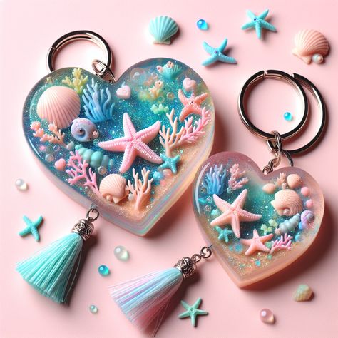 Discover this whimsical under-the-sea themed resin art keychain. Its heart shape encloses a vibrant miniaturized marine world, featuring 3D starfish, seashells, and coral reefs. Glitter adds sparkle and a pastel tassel enhances its cute appeal. Perfect for teenage girls, attached to a silver keyring. 

#ResinArt #Keychain #UnderTheSea #TeenAccessories #GiftForTeens #ResinKeychain Resinart Keychain, Resin Art Keychain, Sea Resin, Resin Things, Marine World, Art Keychain, Resin Keychain, Coral Reefs, Diy Resin Crafts