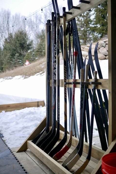 This is the second winter that we have built a backyard ice rink and I decided this year that we needed to get a handle on hockey stick storage rather than just leaning them against the house or piling them up on the ground. We also needed a place to store our cross country skis. I decided to build a freestanding hockey stick rack that would also hold the skis and poles on the other side. This way I could move everything into storage just like it is in the spring. I enjoy projects like… Hockey Stick Storage, Backyard Hockey Rink, Backyard Ice Rink, Backyard Rink, Hockey Diy, Outdoor Rink, Hockey Room, Ski Rack, Hockey Sticks