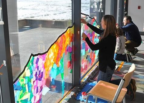 Collaborative Window Collage | Carle Museum Reggio Collaborative Art, Window Art Kindergarten, Childcare Window Ideas, Art Room Windows, Cellophane Window Art, Colored Cellophane Crafts, Art Classroom Decoration Ideas, Crafts To Hang From Ceiling Classroom, Painting Windows Art