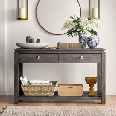 Three Posts Clean lines and a versatile design make this console table the perfect piece for your living space. Crafted from solid and manufactured wood, this console table is a rustic slice of farmhouse decor with its weathered espresso wood hue and decorative handles. And two roll out shelves open up to reveal space for keys or household items. Place it in the living room as a convenient spot for movie, vases, or a small plant. Or, place it in the entryway as a stylish accent piece. Small Buffet Table, Console Table With Shelves, Roll Out Shelves, Table With Shelves, Rustic Console Tables, Console Table Styling, Loft Furniture, Farmhouse Style Table, Console Table Decorating