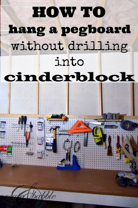 how-to-hang-pegboard-without-drilling-into-cinder-block-by-createandbabble.com Cinder Block Wall Storage, Hanging Pegboard On Wall, How To Hang On Cinder Block Walls, Hang Pegboard On Wall, How To Install Pegboard, Hang Pegboard, Hang Shelves, Basement Craft Rooms, Basement Paint Colors