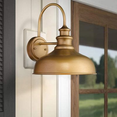 This farmhouse wall light is made of metal construction with gold finish. The gooseneck arm design brings you a simple feeling to your place. Hard wired. Includes all mounting hardware for quick and easy installation. Ideal for barn, warehouse, covered porch, living room, bedroom, kitchen, entryway Finish: Gold | Longshore Tides Azeezah Armed Sconce Metal in Yellow | 13.5 H x 13.1 W x 13.1 D in | Wayfair Kitchen Sconces, Farmhouse Wall Lighting, Barn Light Fixtures, Porch Light Fixtures, Front Porch Lighting, Classic Wall Lights, Cottage Lighting, Porch Living, Exterior Light Fixtures