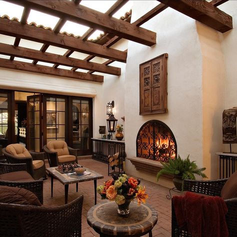 Higgins Architects | Our Spanish Colonial home on Valley Vista has this wonderful interior courtyard with a fireplace & trellis. Natural light is brought into… | Instagram Spanish Hacienda Interior Design, Spanish Colonial Patio, Spanish Hacienda Interior, Spain Style Home, Spanish Style Homes Interior Decor Living Room, Small Spanish Style Homes Interior Decor, Spanish Style Sunroom, Spanish Style Home Living Room, Spanish Western Home