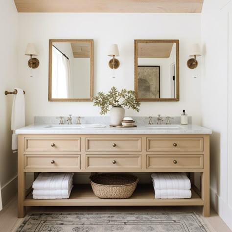 A white modern farmhouse bathroom with natural oak wood bathroom double vanity, white marble countertops, vintage gold bathroom mirrors, vintage gold sconces with white hoods, and a vintage rug. Design: @windthekey Follow @windthekey for more design inspiration. Light Wood Double Vanity Bathroom, Classic Bathroom Vanities, Double Vanity Styling, Light Wood Double Vanity, Double Vanity Bathroom Design, Double Vanity Mirrors And Lights, Light Oak Vanity Bathroom, Natural Wood And White Bathroom, Bathroom Vanity Double