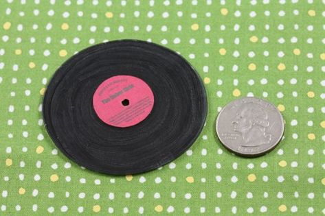 Here's a small project for the audiophile dad - tiny vinyl records! We used shrinky dinks and paint to make this simple and fun craft for Father's Day. I've supplied you with a printable template to get the dimensions just right. You could make this in your own style with personalized songs and album art as we've done here. Include it with a gift certificate to a record store or iTunes. You'll need shiny clear shrinky dink plastic, black acrylic paint and paintbrush, sharp... Diy Mini Vinyl Record, Doll Hair Detangler, Record Diy, Fun Kids Crafts, Diy Father's Day, Christmas Things To Do, American Girl Diy, American Girl Doll House, American Girl Doll Diy