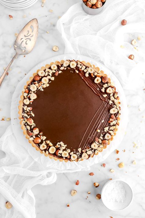 Rich, silky smooth, and extra chocolate-y! That's the perfect way to describe this simple, yet delicious Chocolate Tart with Hazelnut Crust. Perfect for Valentine's Day, celebrations, or just weekend baking! Tart Base, Hazelnut Crust, Hazelnut Tart, Bakers Table, Caramel Tart, Tarts Crust, Chocolate Curls, Baked Rolls, Tart Shells