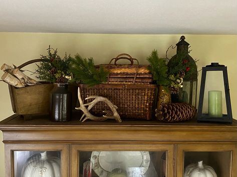 Corner Hutch Christmas, How To Decorate Top Of Armoire In Bedroom, Christmas Decor Ideas For Top Of Entertainment Center, Christmas Decor On Top Of Hutch, Winter Hutch Decor, Top Of Armoire Decor, Decorating Top Of Hutch, Western Bookshelf, Top Of Hutch Decor