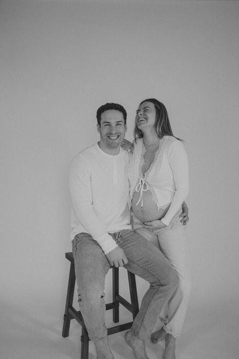 Backdrop Maternity Photos, Sit Down Maternity Photos, Maternity Shoot With Stool, Stool Maternity Shoot, Seated Maternity Photos, Sitting Maternity Poses, Couple Maternity Pictures Studio, Maternity Pictures White Backdrop, Maternity Stool Pose