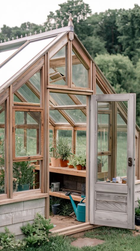 Reclaimed Window Greenhouse on backyard with plants and gardening tools inside. Budget Greenhouse Diy, Tiny Greenhouse Ideas, Make Your Own Greenhouse, How To Build A Greenhouse, Small Walk In Greenhouse, Diy Greenhouse With Old Windows, Small Backyard Spaces, Small Greenhouse Ideas, Small Green House